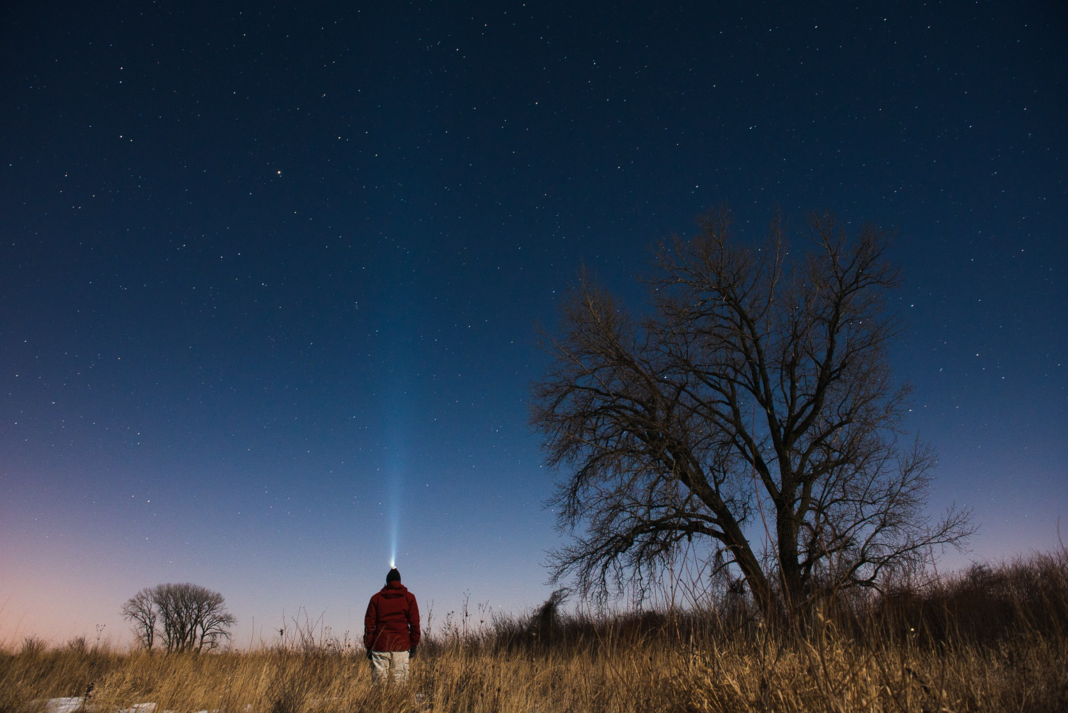 Eric standing with headlamp into starry sky